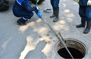 Drain technician checking a sewer line after emergency drain cleaning